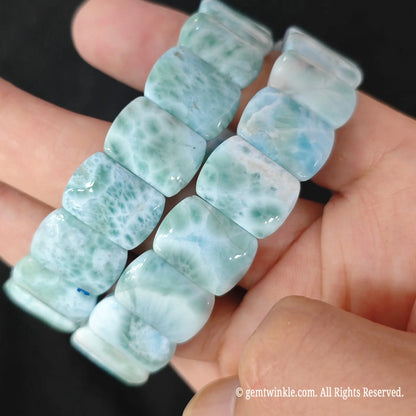 Side view of polished natural larimar rectangle bead bracelet showing glossy surface and natural wave matrix