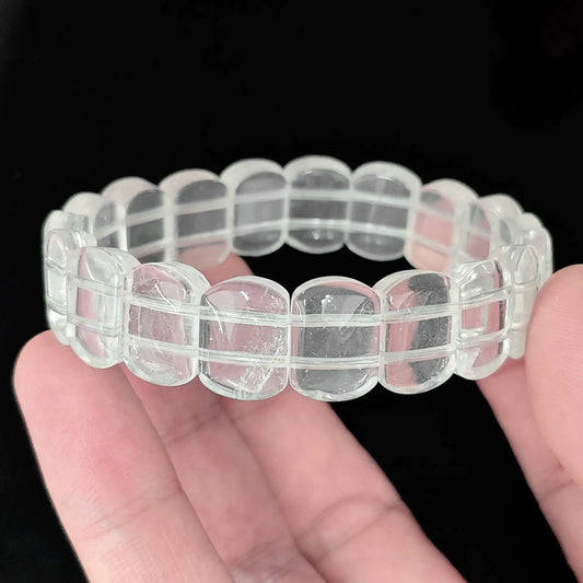 Natural milky quartz 14mm smooth rectangular bead bracelet held in hand showing rounded polished edges