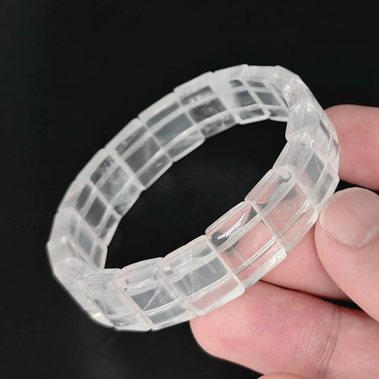Natural milky quartz 15mm smooth rectangular block bead bracelet held in hand showing glossy polished surface