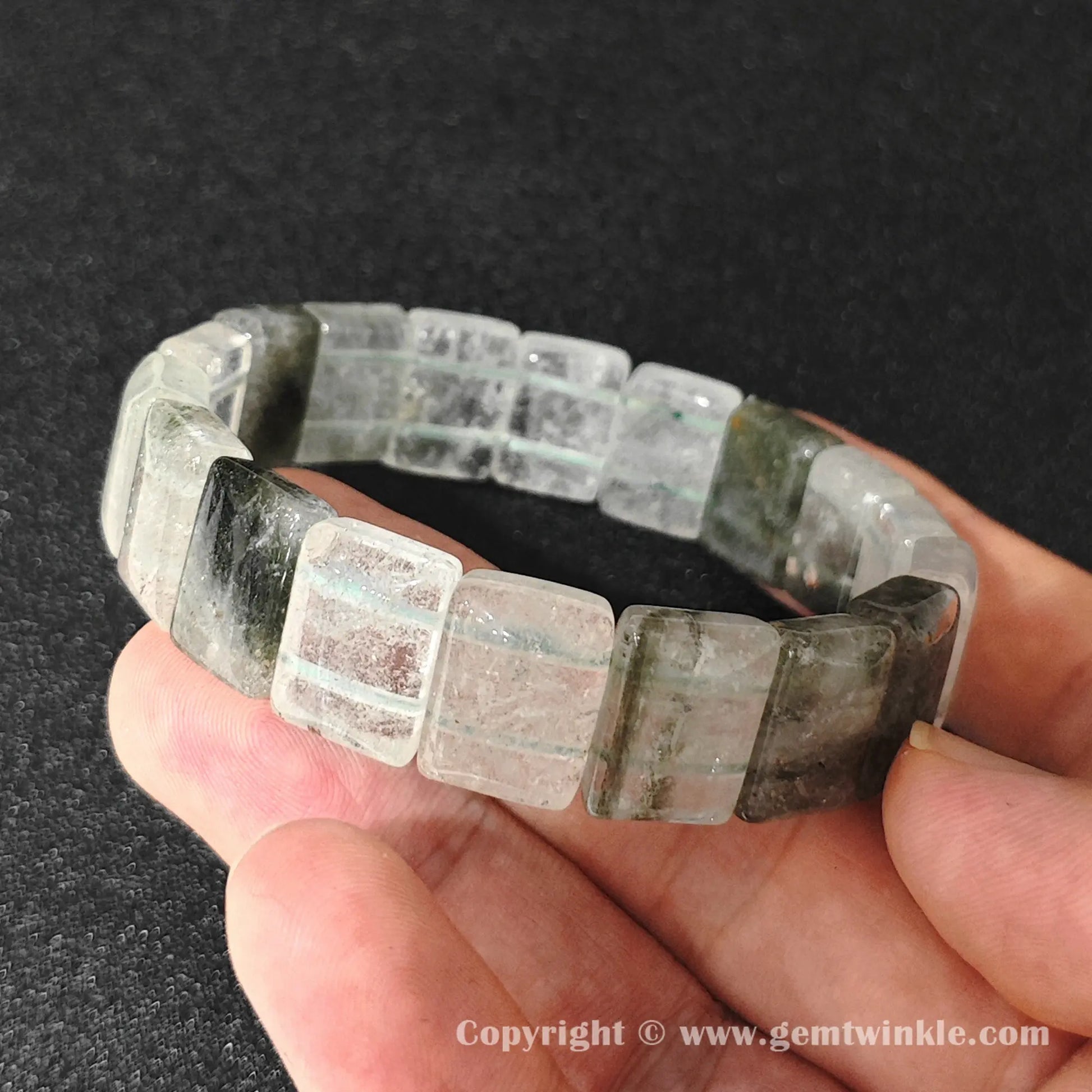 angled view of natural misty garden quartz plate beads stringed on durable elastic cord