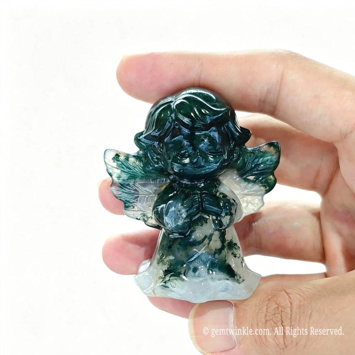 Single natural green moss agate praying angel statue 6cm height held in hand showing green plant-like inclusions