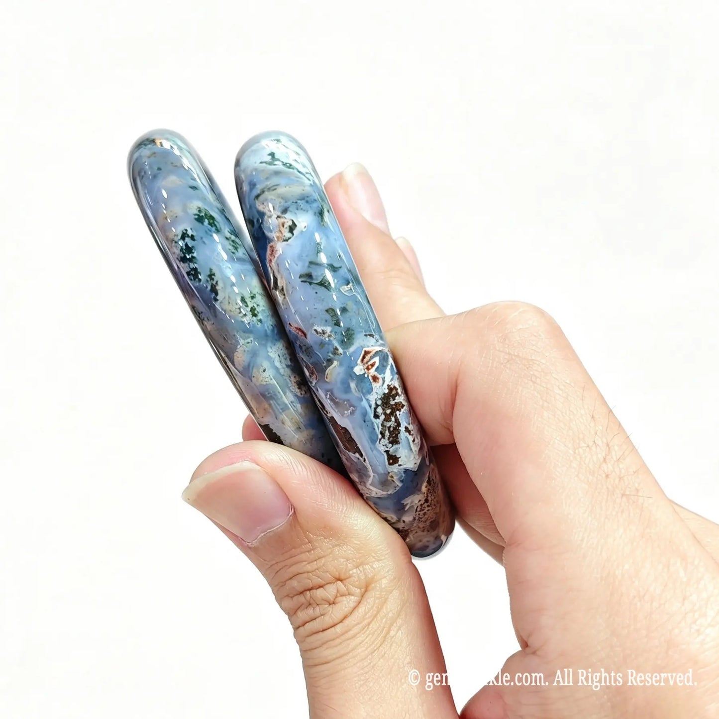 Two polished natural ocean jasper bangles displayed together for boutique inventory