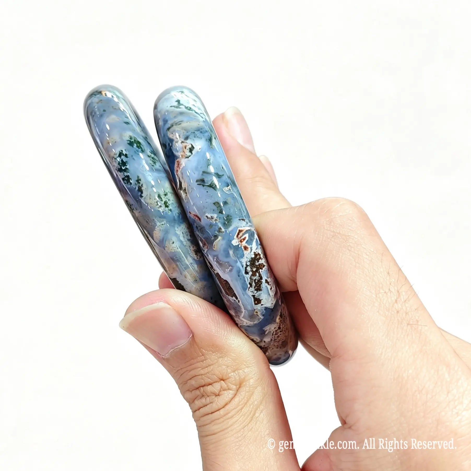 Two polished natural ocean jasper bangles displayed together for boutique inventory