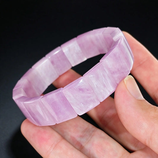 natural pink kunzite 15x11mm bamboo segment gemstone bracelet held in hand displaying pastel lilac color