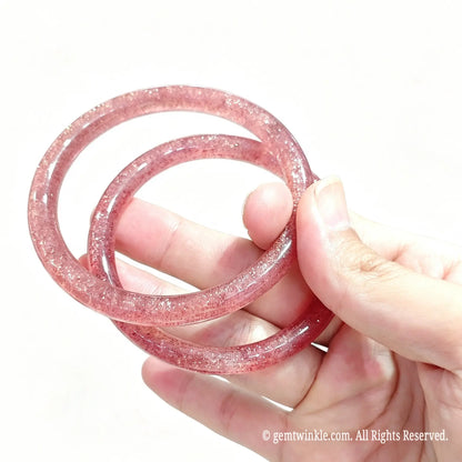Pair of natural red inclusion quartzite bangles showing translucent quartz matrix and magenta flecks