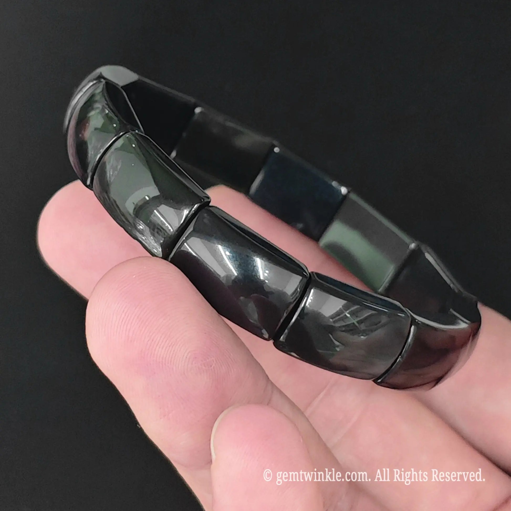 Natural rainbow eye obsidian rectangle plate bracelet displayed vertically highlighting uniform plate bead arrangement