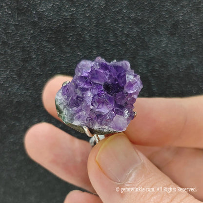 Natural raw amethyst cluster ring showcasing the textured adjustable alloy ring band and organic stone base