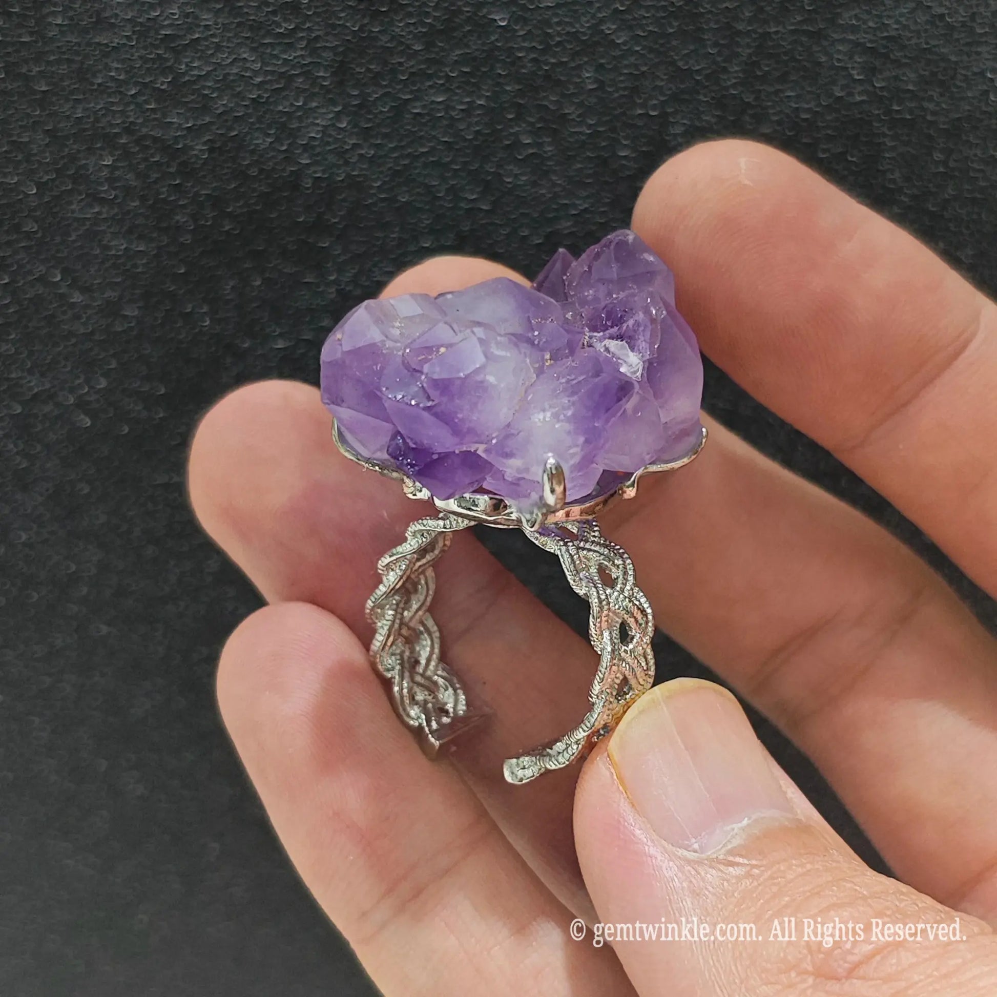 Natural raw amethyst point cluster ring showcasing the textured filigree alloy ring band and raw stone underside