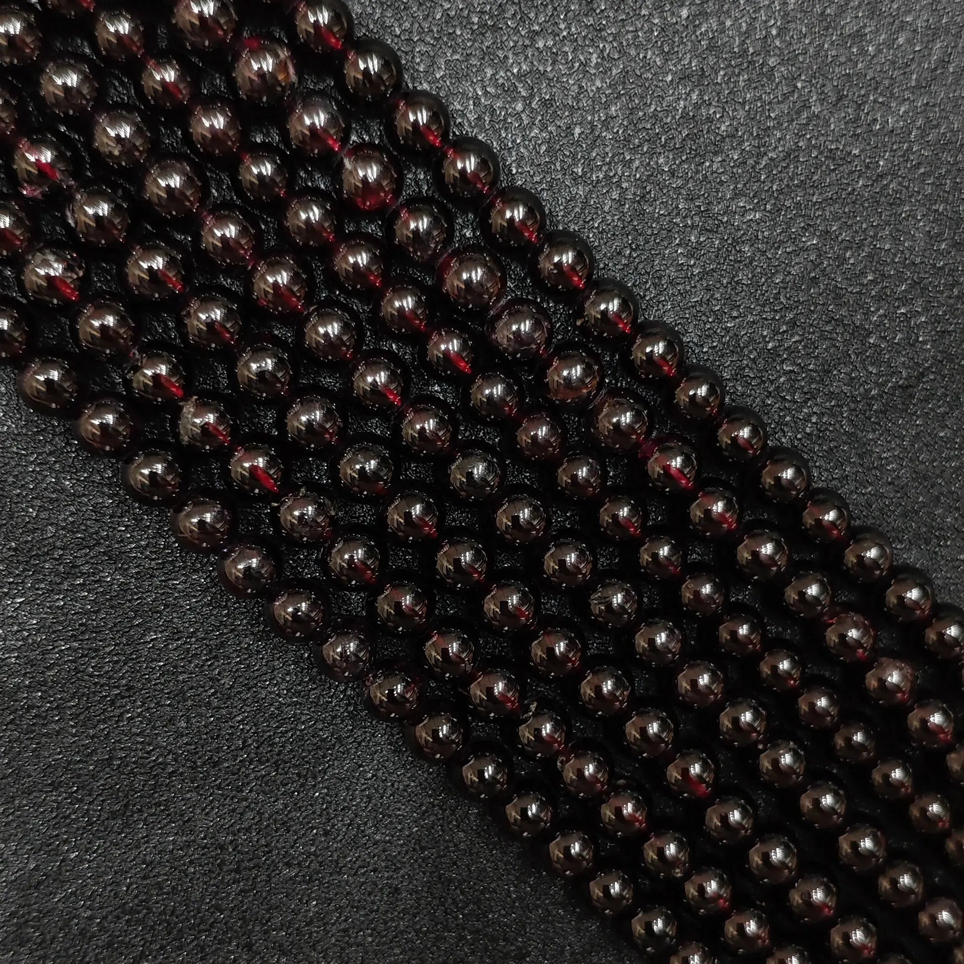 deep wine red natural garnet crystal beads loose strands close up view