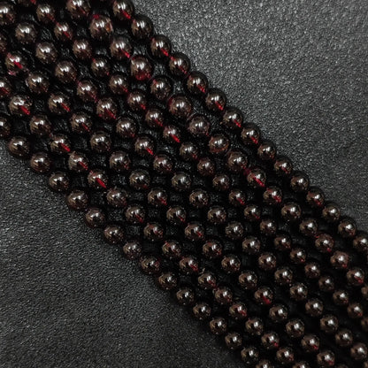 deep wine red natural garnet crystal beads loose strands close up view