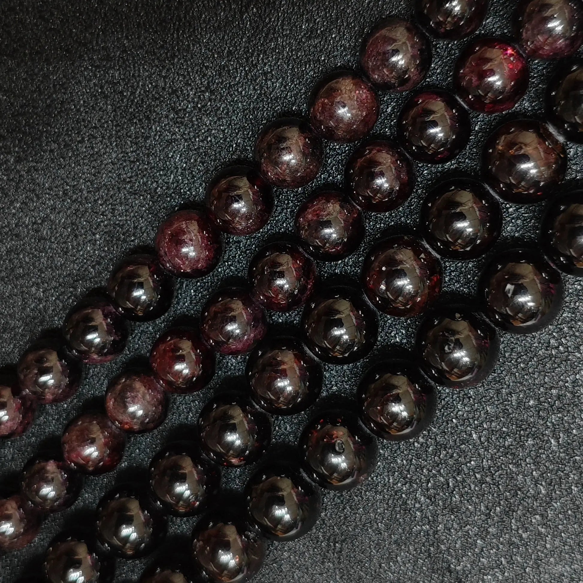 opaque dark red garnet crystal beads with visible natural surface growth lines