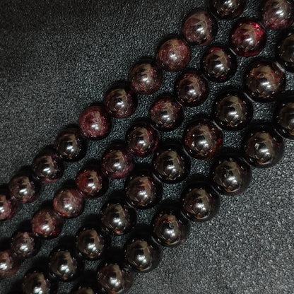 opaque dark red garnet crystal beads with visible natural surface growth lines
