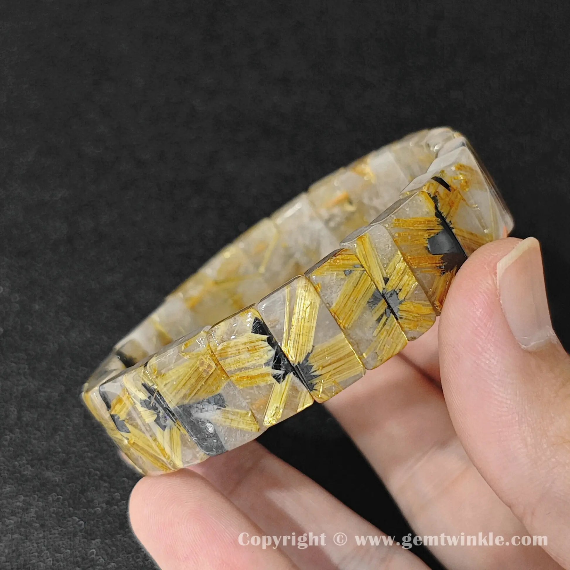 golden rutilated quartz plate bead bracelet displayed over hand showing glossy surface finish