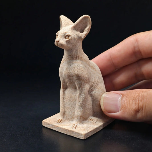natural beige sandstone egyptian bastet cat statue held in hand displaying carved feline figure and base