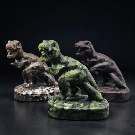 group display of natural green serpentine and dark red spotted stone t-rex dinosaur statues on bases