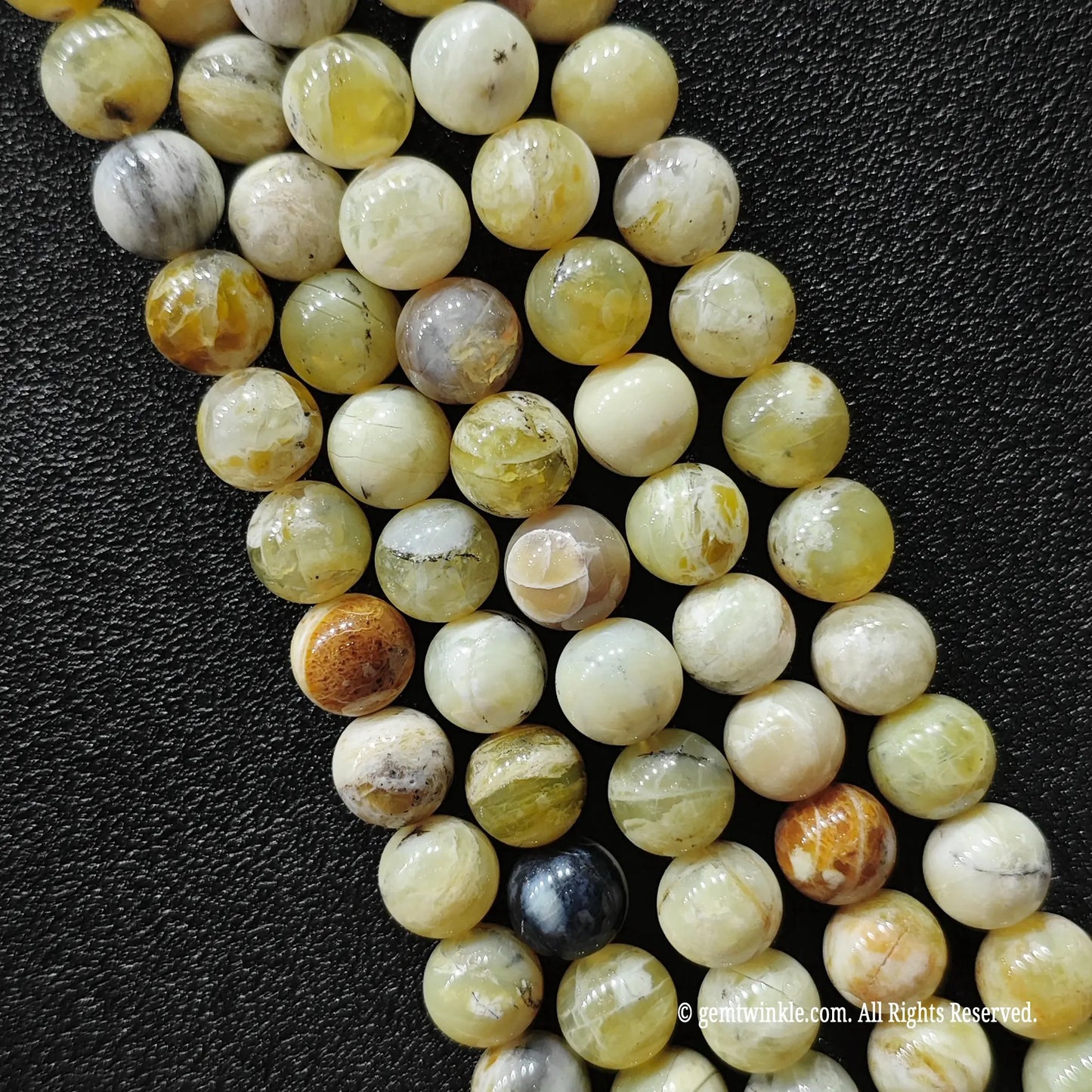standard grade natural stones for jewelry making wholesale showing polished round yellow opal strands with rustic matrix patches