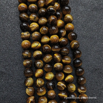 Macro view of raw grade b minus yellow tiger eye strands showing natural ice cracks and organic texture