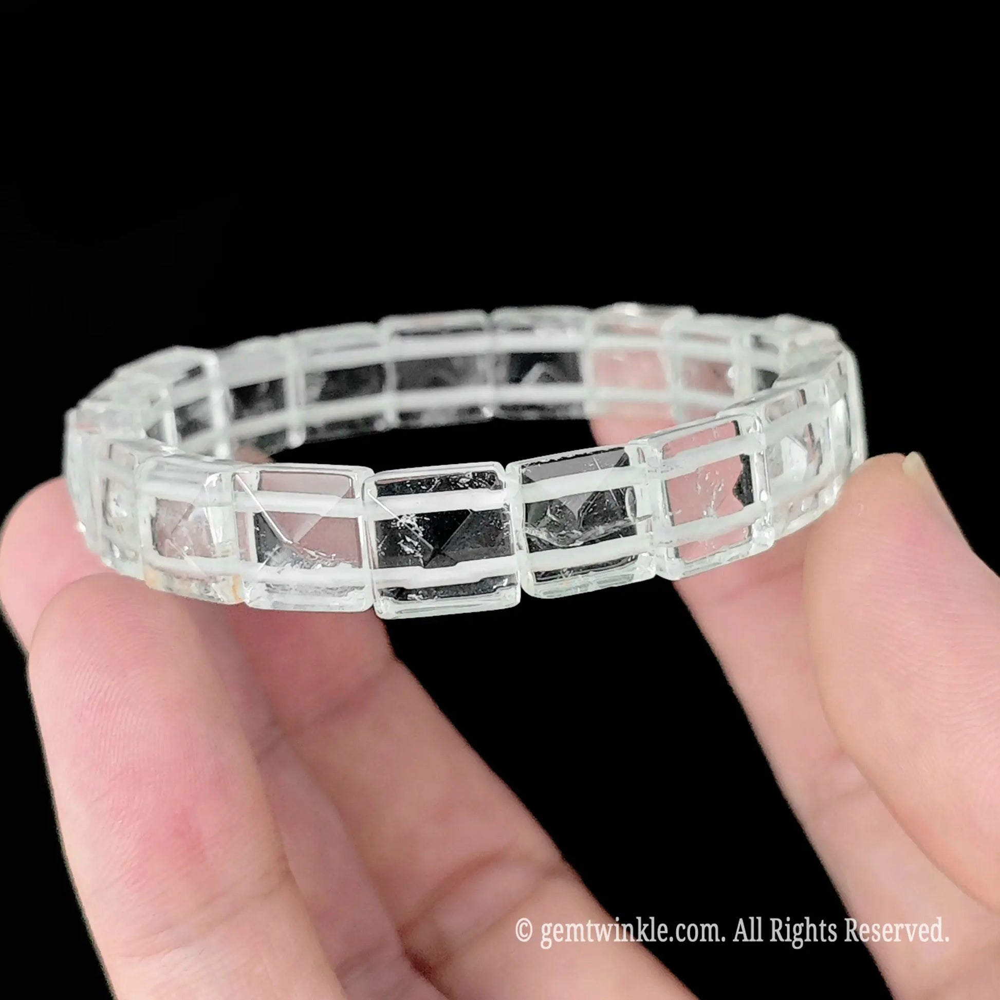 Natural white crystal pyramid stud square bead bracelet held horizontally showcasing uniform bead alignment