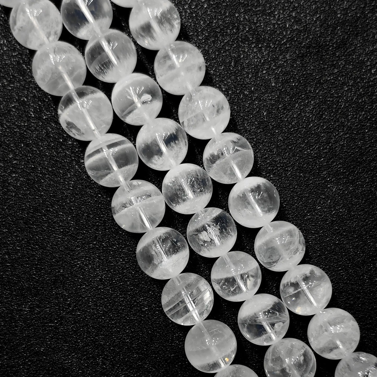 close up of natural white phantom quartz beads showing unique inner ghost formations