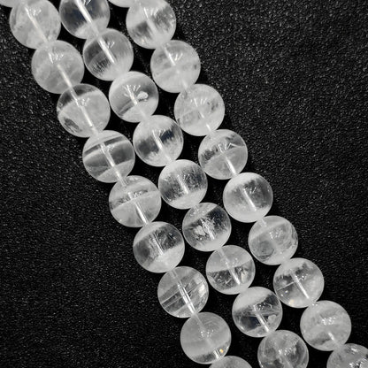 close up of natural white phantom quartz beads showing unique inner ghost formations