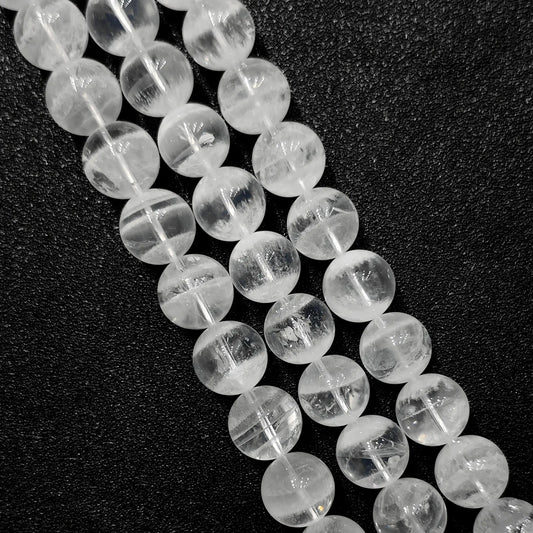 close up of natural white phantom quartz beads showing unique inner ghost formations