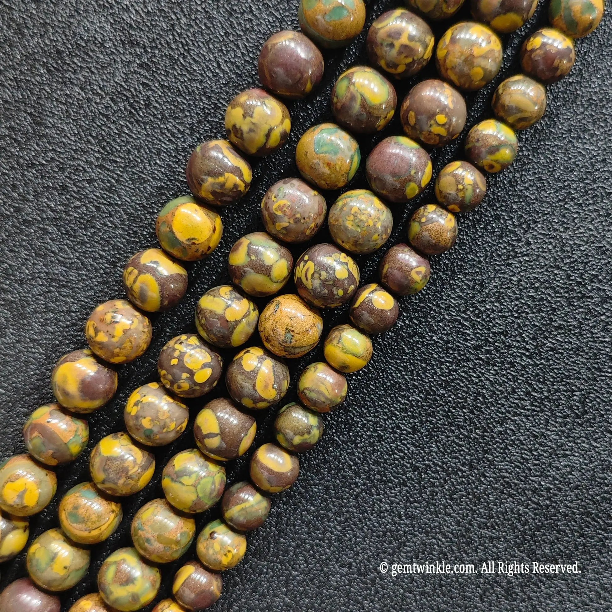 untreated earthy nuwa stone crystal round beads strands showing natural yellow green and brown mottled patterns