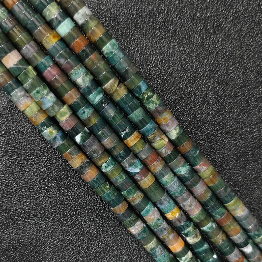 Macro closeup of natural ocean jasper heishi rondelle beads 6x3mm showing orbicular mossy patterns