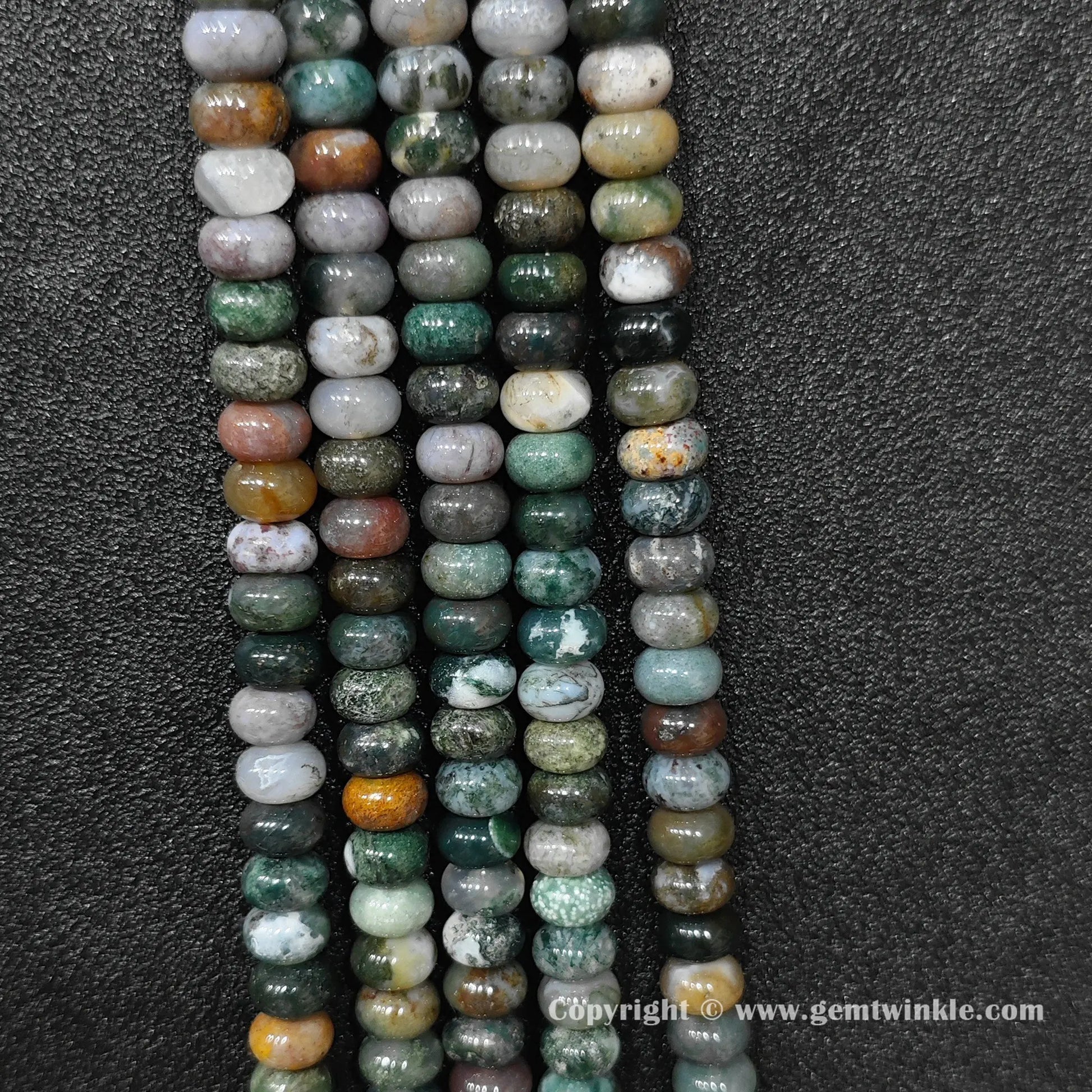Perspective view of ocean jasper smooth heishi spacer beads showing uniform 6mm disc thickness