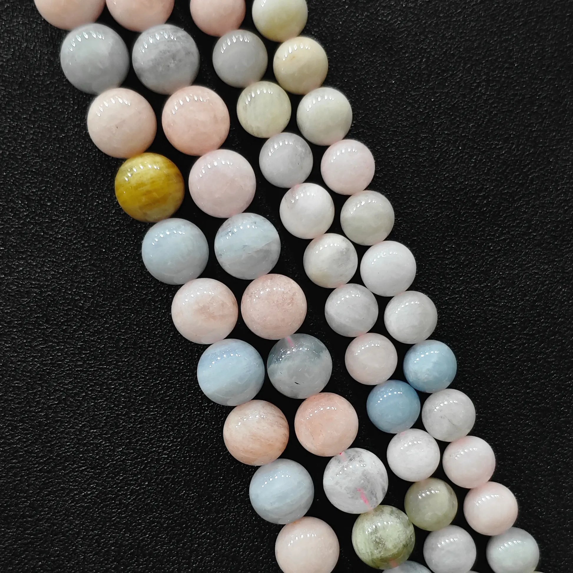 Close up view of opaque multi color morganite crystal beads strands in B-grade showing rich porcelain pastel pink and blue beryl minerals in image_cc95a3.jpg