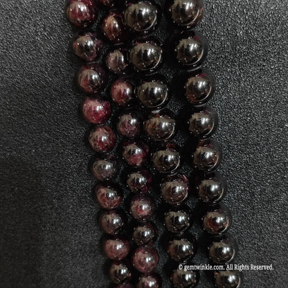 close up of primitive style red garnet gemstone beads highlighting extensive ice cracks