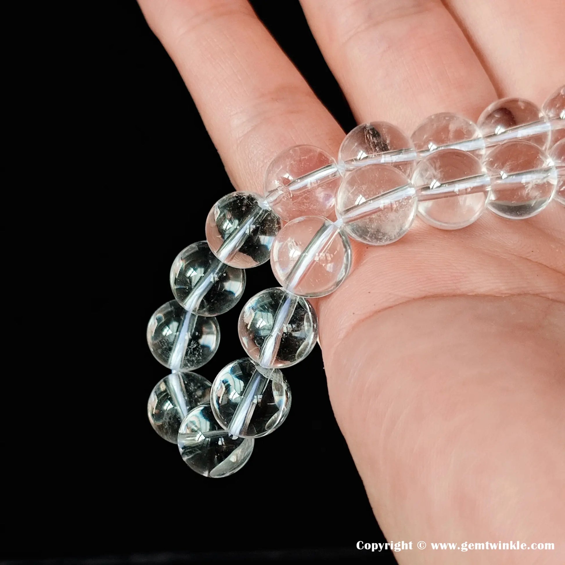 ive smooth natural clear quartz crystal round beads for jewelry making, showing fine internal ice cracks that add an authentic earthy character