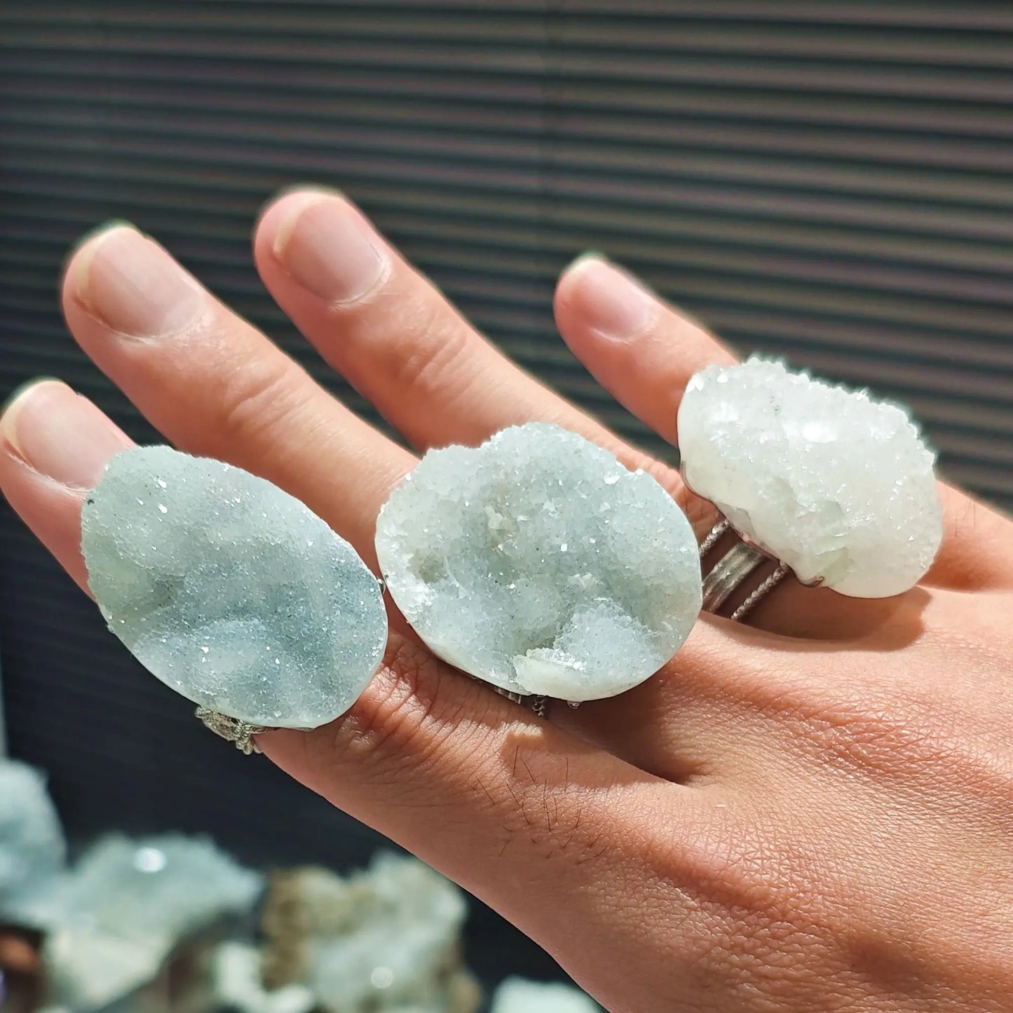 oversized boho white druzy ring collection highlighting raw mineral contours and icy hues