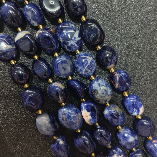 natural blue sodalite freeform pebble bead strand displaying rich royal blue tumbling nuggets with white calcite veining