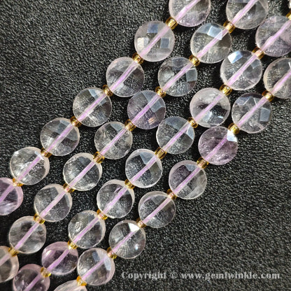 Close up view of pale violet quartz faceted flat disc beads displaying geometry facets