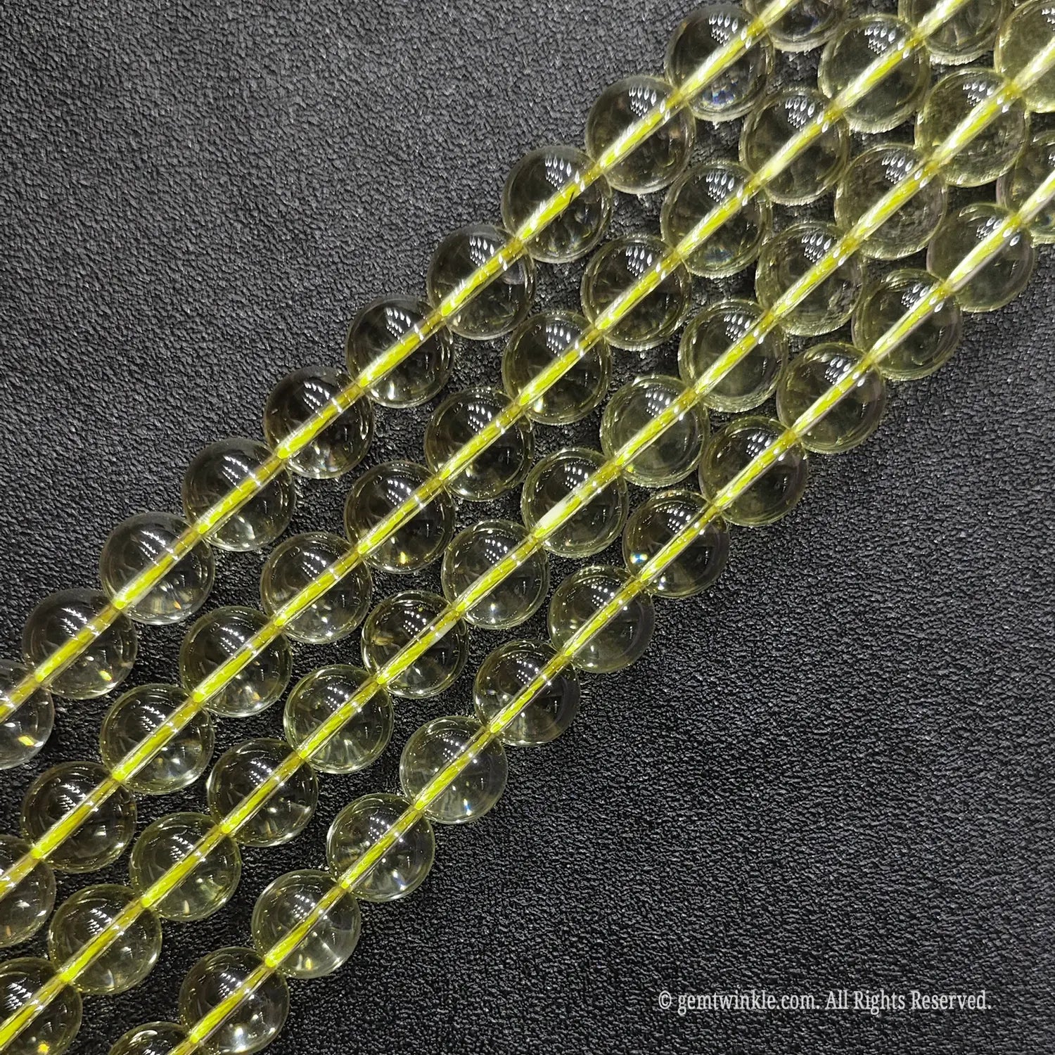 Close up of A grade pale yellow citrine crystal round strands with superior high polish and minimal inclusions