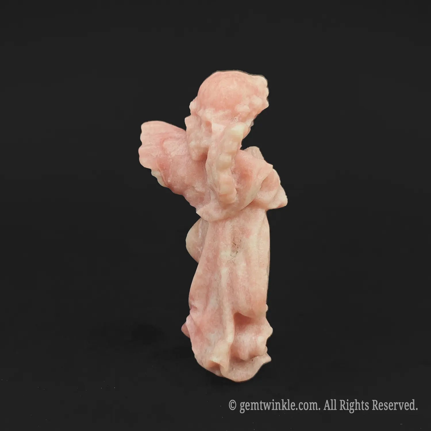 Back view of a hand-carved pink opal angel figurine displaying consistent pastel pink hues, ideal for aesthetic room decor wholesale