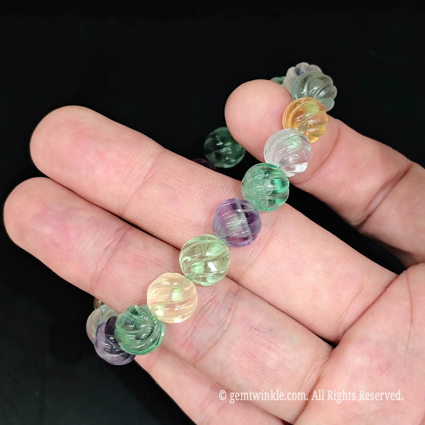Pastel fluorite carved pumpkin bead stretch bracelet side view highlighting detailed carved grooves and natural inclusions