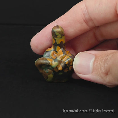 Close up of a 4cm patterned matrix stone middle finger figurine for office desk humor