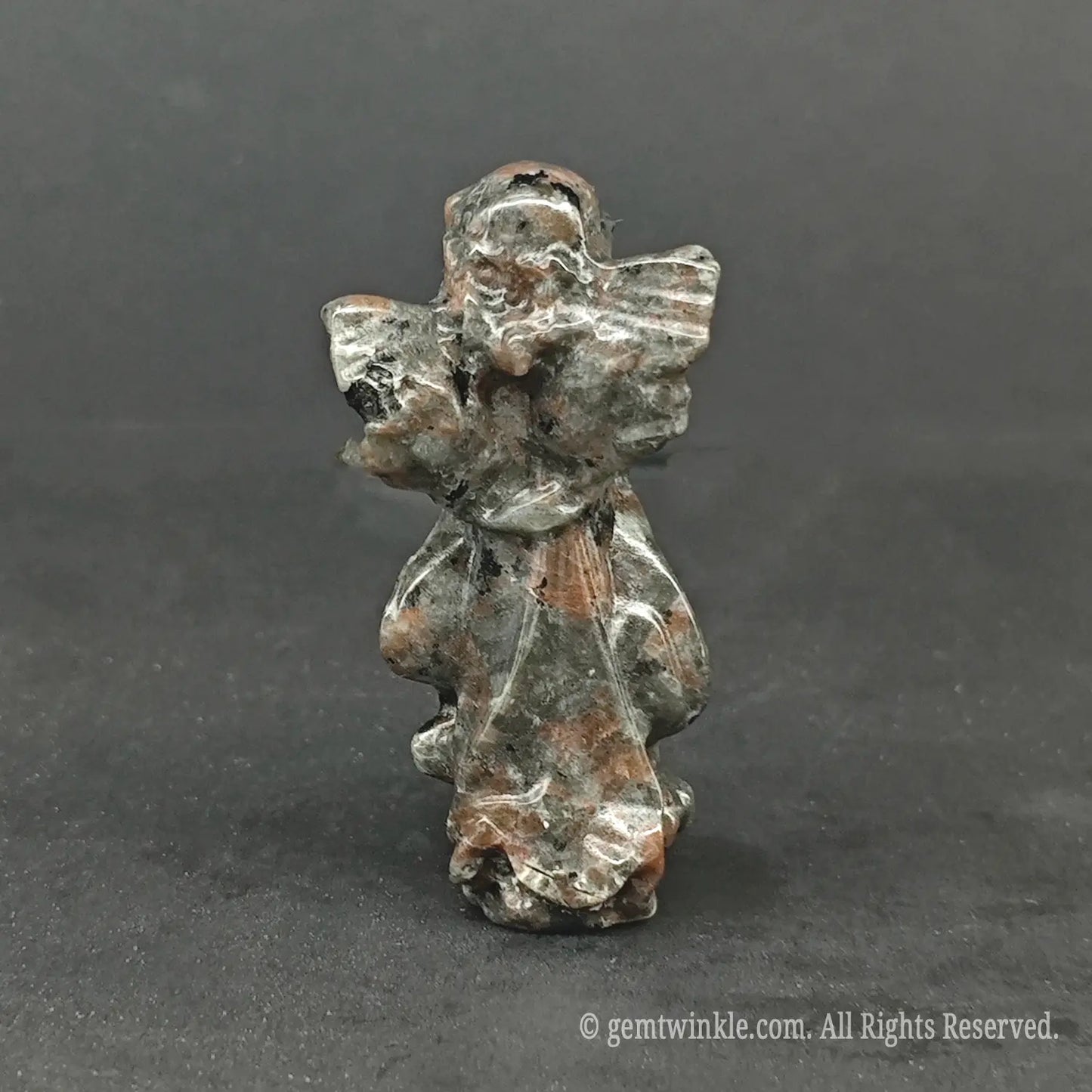 Back view of a natural speckled matrix granite stone angel carving with polished wings, perfect for minimal wabi-sabi and cottagecore decor