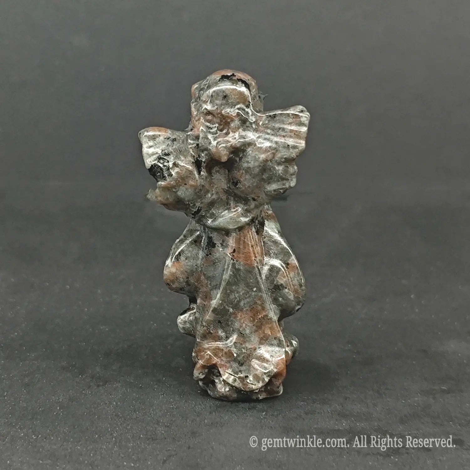 Back view of a natural speckled matrix granite stone angel carving with polished wings, perfect for minimal wabi-sabi and cottagecore decor