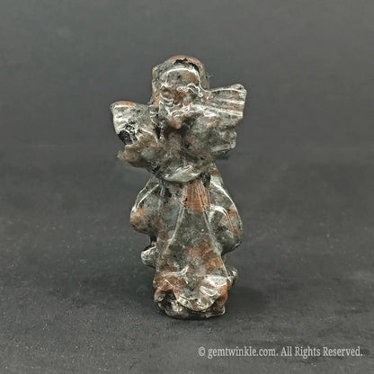 Back view of a natural speckled matrix granite stone angel carving with polished wings, perfect for minimal wabi-sabi and cottagecore decor