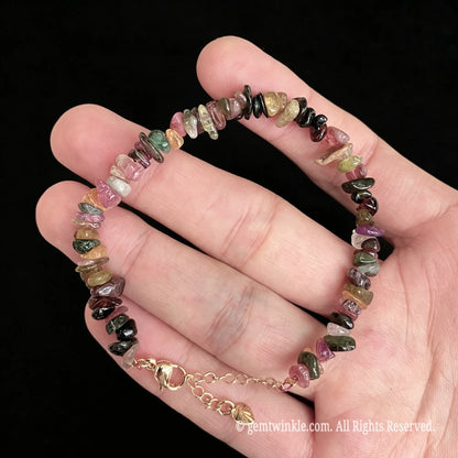 pink and green tourmaline chip bracelet resting on palm showing natural bead layout