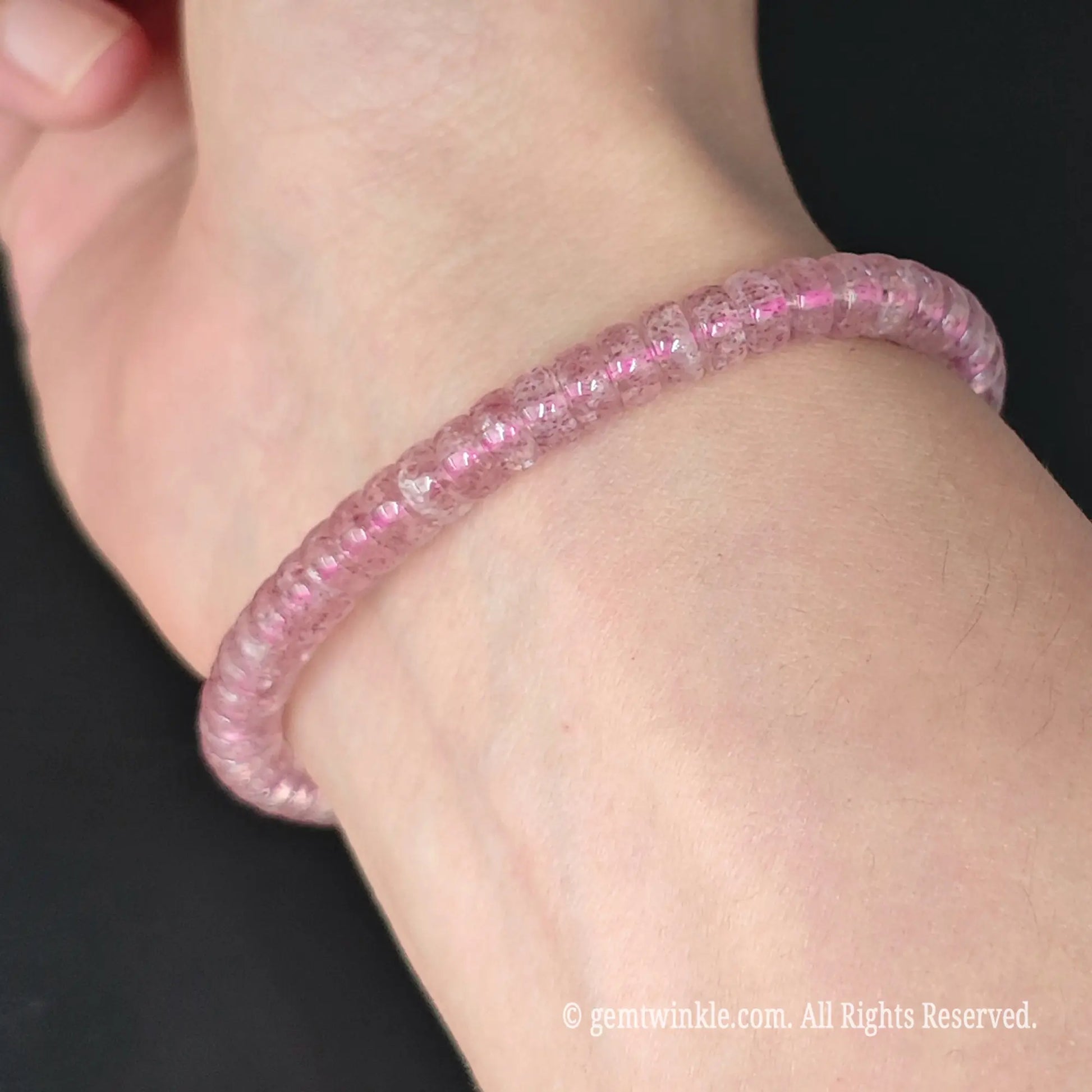 side view of 16cm womens pink strawberry quartz rondelle bead stretch bracelet