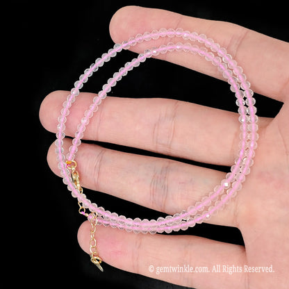 faceted rose quartz micro bead necklace loop with gold tone extender chain in hand