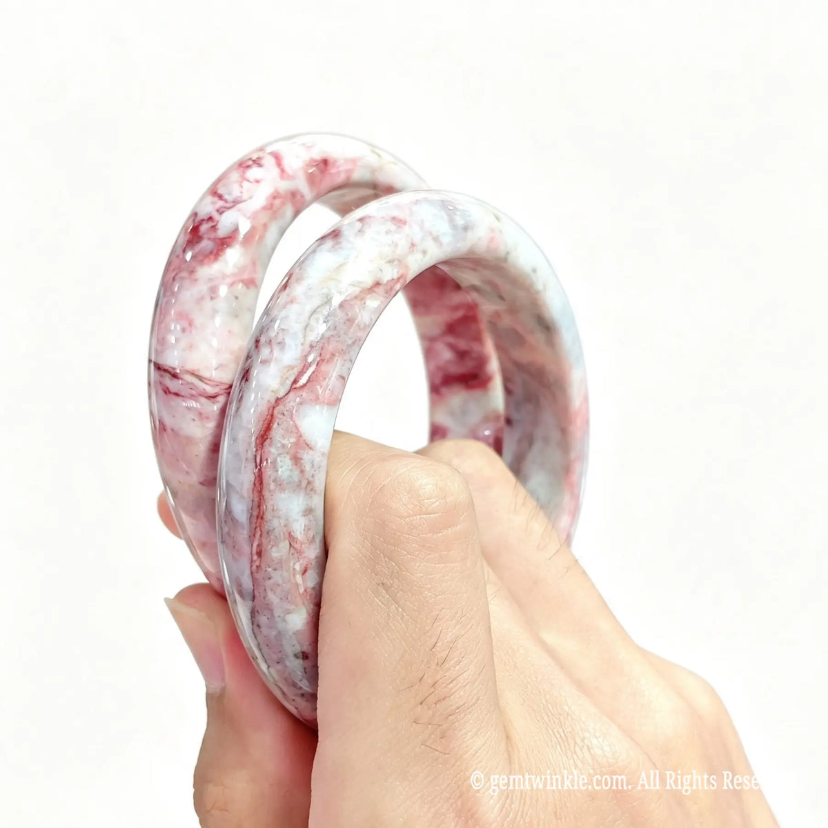 Pair of pink cinnabar matrix wristbands showing custom inner diameter sizing and price tiers