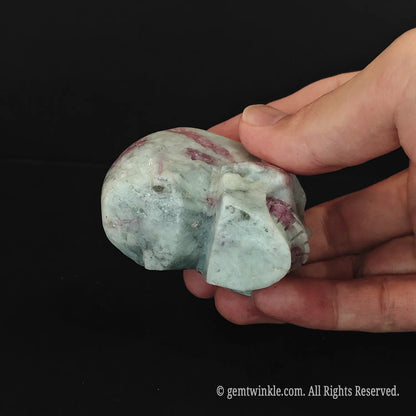 Frontal look at two 6cm pink tourmaline crystal skulls showing detailed hollowed facial orbits
