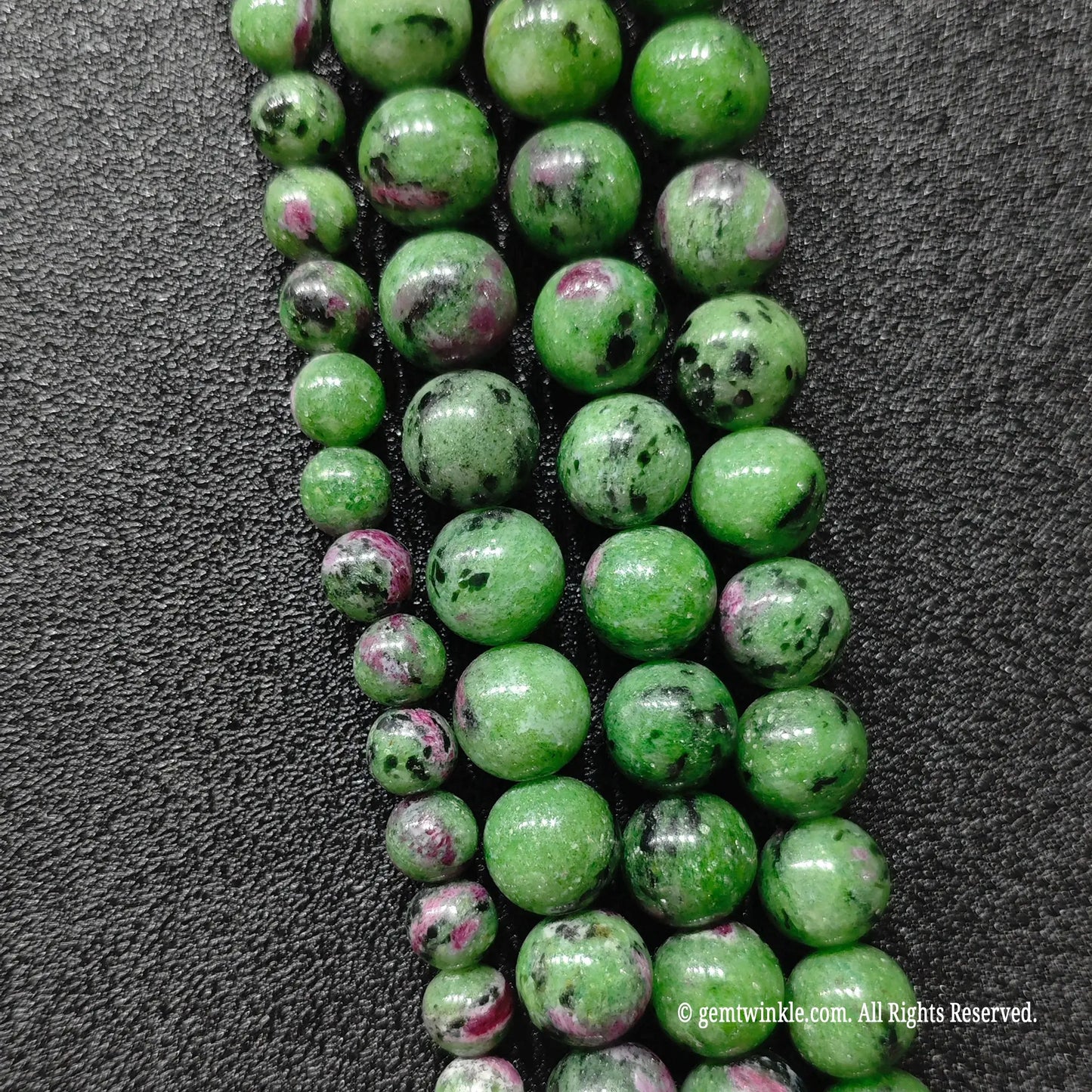 commercial grade ruby in zoisite polished round stone strands showcasing authentic mineral mosaic texture