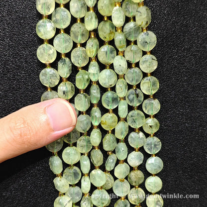 Hand holding strands of prehnite hexagram flat disc beads in 8mm and 10mm