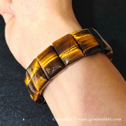 golden yellow tigers eye plate cuff bracelet worn on wrist showcasing 17-18cm fit and glossy finish