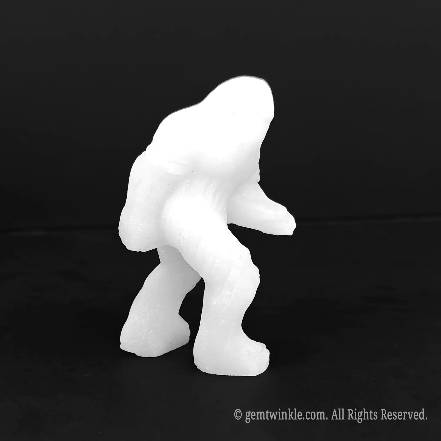 Front view of a pristine white marble yeti sasquatch sculpture standing independently showing clean minimalist carving details